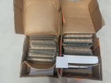 two boxes with a bunch of nails inside of them