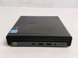 laptop computer sitting on top of a white surface with a blue sticker on it