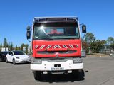 a red and white truck parked in a parking lot