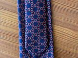 a close up of a tie on a wooden table