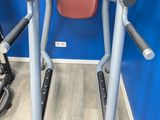 two stationary exercise machines in a gym room