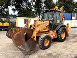 an image of a backhoe loader in a parking lot