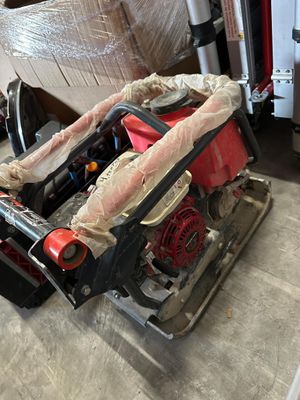 a picture of a red and black machine in a garage