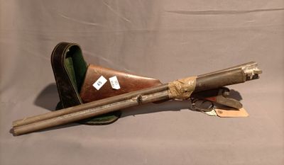 a gun and a pair of sticks on a table