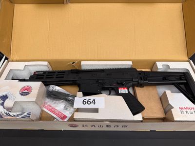 a gun in a box with other items in it