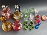 many different colored glass vases sitting on a table