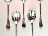 five spoons and two spoons on a white surface