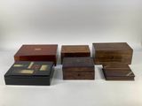 a group of four wooden boxes sitting on top of a white surface