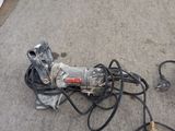 a picture of a corded drill and a corded drill on the floor