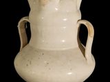 a white vase with two handles on a black background