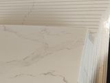 several sheets of white marble are stacked on top of each other