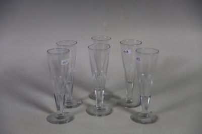 four empty wine glasses sitting on a table with a white background