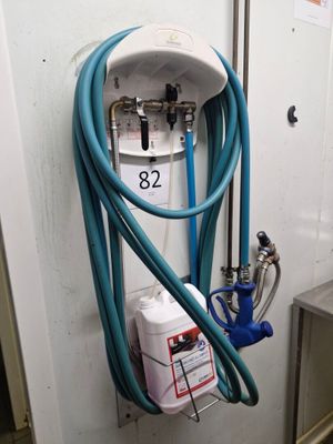 a blue hose attached to a white wall with a blue hose attached to it