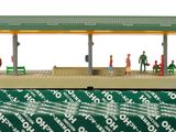 a small model of a train station with people on the platform