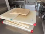 a stack of cutting boards sitting on top of a kitchen counter
