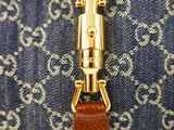 an image of a close up of a purse with a key