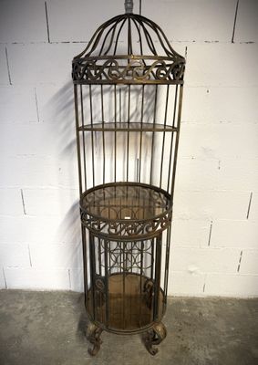 an image of a birdcage with a shelf on top of it