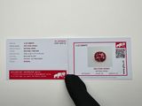 a person pointing to a red button on a white card