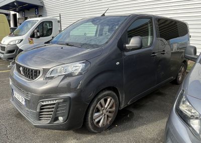 a grey van parked in a parking lot next to other cars