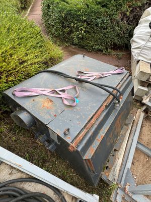 a metal box that has a pair of scissors on top of it