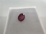 a close up of a pink diamond on a white surface