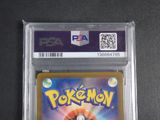 a close up of a pokemon card in a plastic case