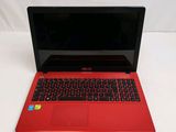 a red laptop with a black keyboard on a white surface