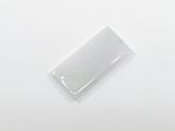 rectangular white jade stone on a white surface with a small hole in the middle