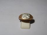 a gold ring with a silver stone in it