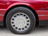 a picture of a red car parked on the side of the road