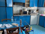 a kitchen with blue cabinets and a blue table and chairs