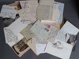 a pile of old letters and postcards on a table