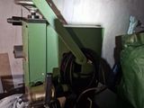 a green machine that is sitting in a room
