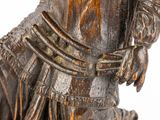 an antique wooden statue of a horse with a rider on it ' s back
