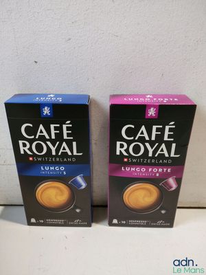 two boxes of cafe royal coffee sitting on a counter