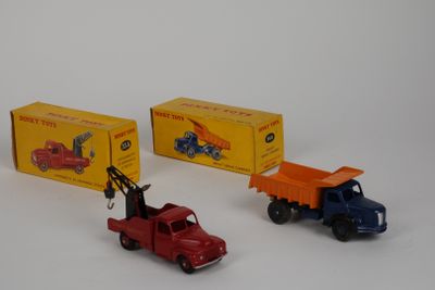 three toy trucks sitting next to each other on a white surface