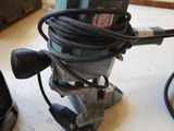 two electric tools sitting on a table in a workshop