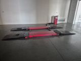 a red fire hydrant sitting on the floor next to a red fire hydrant
