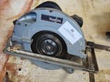 someone is using a circular saw to cut a piece of wood