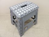 a gray stool with white polka dots on it