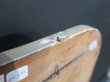 a close up of a piece of wood with a sticker on it