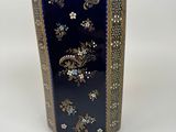 a blue vase with gold and blue designs on it
