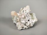 a small piece of rock with a lot of crystals on top of it
