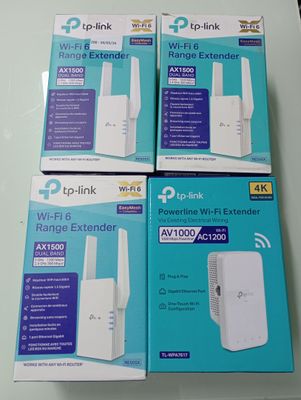 three wi - fi extender boxes sitting on a table next to each other