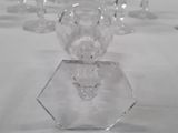 many crystal vases sitting on a table with a white table cloth