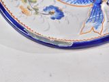 a blue and white plate with a blue bird on it