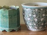 two vases that are sitting on a wooden table