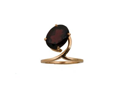 a close up of a gold ring with a garnetite stone