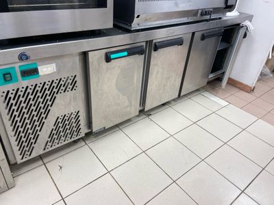 several stainless steel ovens are lined up against a wall in a commercial kitchen