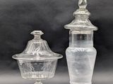 two clear glass containers with lids and a glass lid